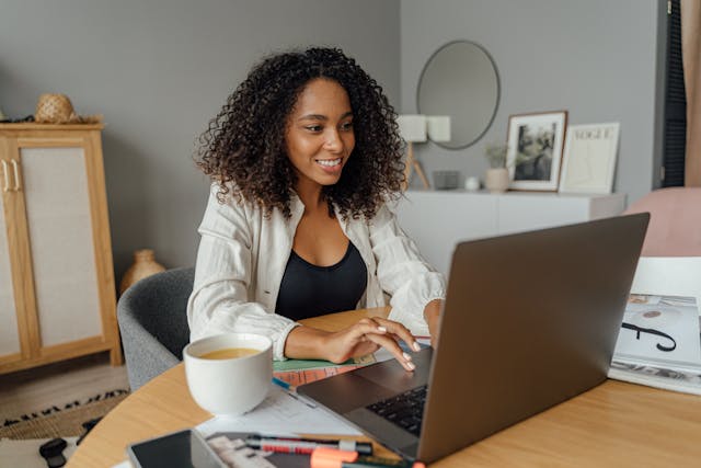 A woman using a laptop in her home